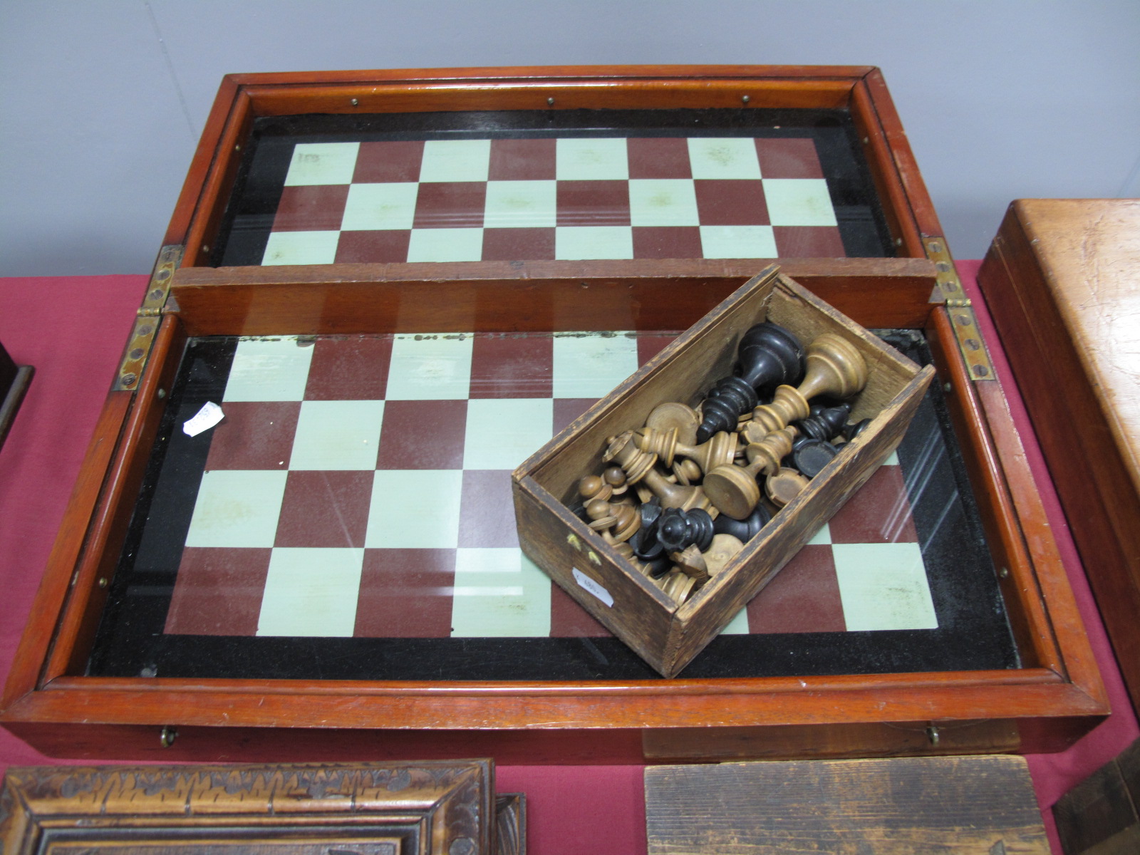 A Victorian Cased Folding Glass Chess Board, together with chess pieces.