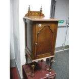 A Circa 1920's Oak Bedside Cupboard, gallery back above hinged door, with interior shelving, on ring