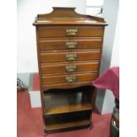 An Early XX Century Mahogany Music Cabinet, with a ¾ gallery, five fall front drawers, over two open