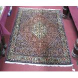 An Iranian Bijar Tasseled Wool Rug, with central hexagonal lozenge and allover floral decoration,