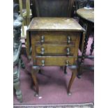 A XX Century Walnut Work Table, with drop leaves, three small drawers and cabriole legs.