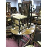 A 1920's Oak Drop Leaf Table, on bobbin and block supports; together with a pair of oak dining
