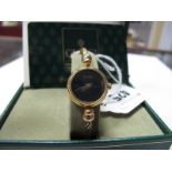 Gucci; A Ladies Bangle Wristwatch, with plain signed black dial, on ropetwist bangle, case