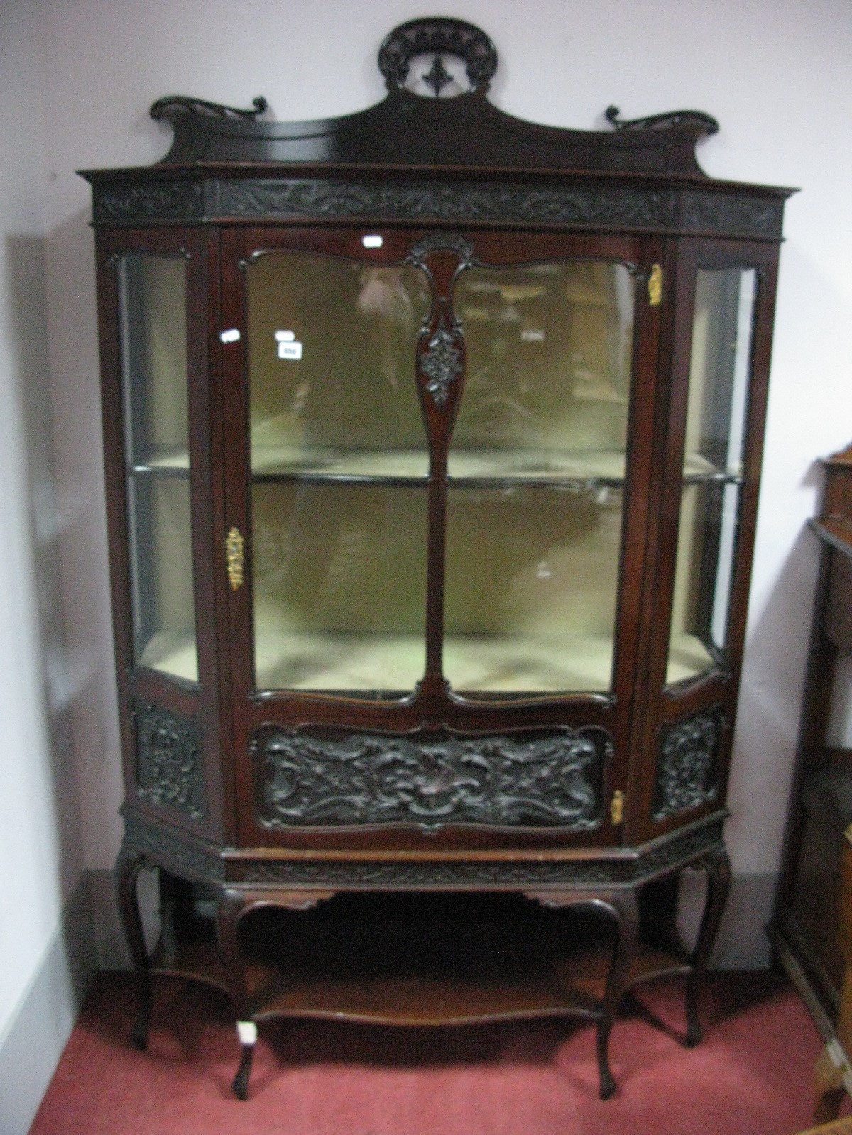 An Edwardian Mahogany Display Cabinet, having pierced and shaped back, canted corners, single glazed
