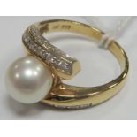 A Pearl Set Ring, set to the centre within crossover setting with inset highlights, stamped "750" "