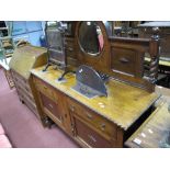 A 1920's Oak Mirror Back Sideboard, arched back with bevelled circular mirror, over two small frieze