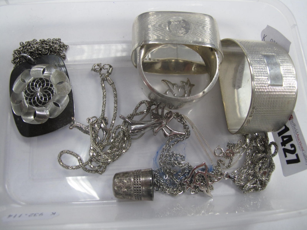 Hallmarked Silver Napkin Rings, pendants on chains, thimble.