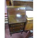 An Edwardian Mahogany Bureau, with a fall front, fitted interior, three drawers, on cabriole legs.