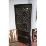 An Oak Corner Freestanding Display Cabinet, having upper lead glazed doors.