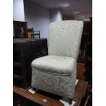 An Early XX Century Nursing Chair, upholstered in a floral fabric.