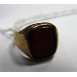 A 9ct Gold Hardstone Inset Ring, the cushion shape panel between plain shoulders.