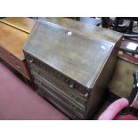 A XX Century Oak Bureau, with fall front, fitted interior, top drawer with knulled decoration, three