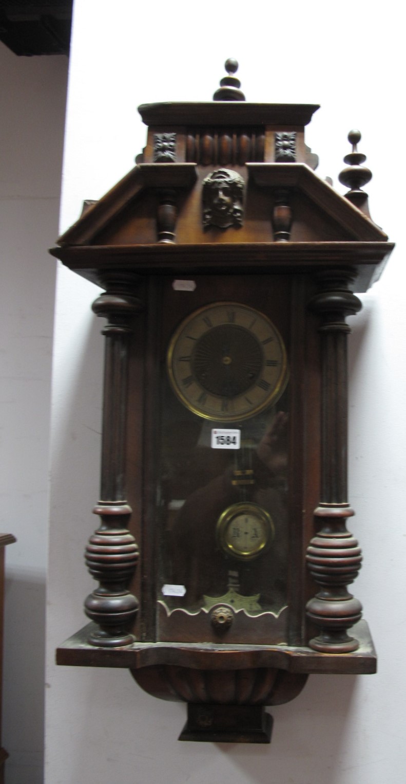 A Circa 1900 Mahogany 8 Day Wall Clock, broken pediment with mask head and half turned columns, over