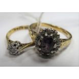 An 18ct Gold Cluster Ring, oval claw set to the centre; together with a single stone ring,