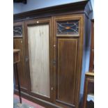 An Edwardian Mahogany Triple Wardrobe, (no central mirror), flanking panelled doors, plinth base.