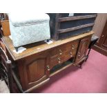An Early XX Century Oak Sideboard Base, with two central drawers, flanking cupboards, on cabriole