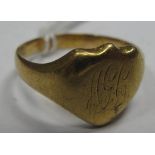 An 18ct Gold Gent's Signet Ring, the shield shape panel indistinctly initialled (rubbed), between