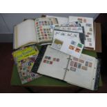 A Small Box Containing Four Albums of All World Used Stamps, including a small selection of first