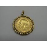 A Sovereign, 1911, GF. Hard mounted in a pendant.