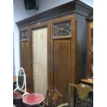 An Edwardian Mahogany Triple Wardrobe, (no central mirror), flanking panelled doors, plinth base.