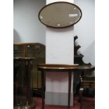 A Mahogany Demi-Lune Consul Table; together with a oval mahogany shaped wall mirror. (2)