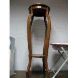 An Edwardian Mahogany Plant Stand, with circular top and undershelf united by sabre legs.