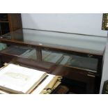 An Early XX Century Mahogany Table Top Display Counter, with brass handles to twin drop doors,