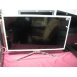 A Samsung 32" Flat Screen Television, white with remote control.