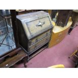 A 1920's Oak Bureau, with fall front, fitted interior, over two drawers, on barley twist legs.