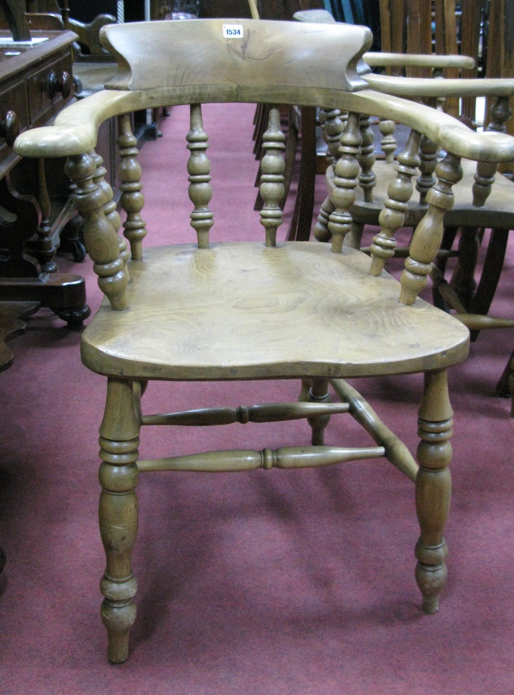 A XIX Century Ash and Elm Pad Arm Chair, with low bock, shaped arms, turned spindles, legs and