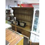 A Pine Dresser, with planked two shelf rack, three drawers, two cupboard doors and pot board to