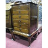 An Early XX Century Beech Music Cabinet, with six fall front drawers on cabriole legs, and sheet