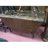 An XVIII Century Oak Oval Topped Drop Leaf Dining Table, on tapering legs with pad feet.