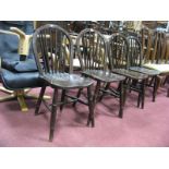 A Set of Four XX Century Ash - Elm Windsor Chairs, with hooped backs, rail supports, on turned legs,