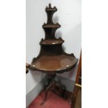 A Reproduction Mahogany Four Tier Waterfall Corner Shelf, shaped supports and apron piece, all