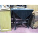 An Ebonised Early XX Century Card Table, with fall flaps, splayed feet, united by openwork panels.