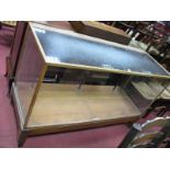 An Oak Shop Display Cabinet, with glazed top, front and sides, on square tapering supports, (bearing