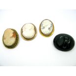 An Oval Shell Carved Cameo Brooch, depicting female profile; together with two further examples