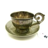 A Russian Cup and Saucer, leaf engraved, the cup with flat scroll handle, the saucer 11.6cm