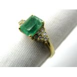 A Single Stone Emerald Ring, rectangular four claw set to the centre, between tapering shoulders,