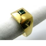 An Unusual Emerald and Diamond Set Three Stone Ring, of plain tapering design, square claw set to