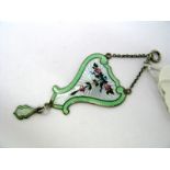 A Hallmarked Silver and Enamel Pendant, of shaped design, detailed with roses on a white ground,