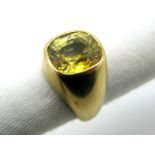 A Gent's Single Stone Ring, collet rubover set with a cushion shape yellow sapphire, stamped "