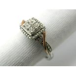 A Diamond Set Dress Ring, of cushion shape between crossover shoulders, stamped "925 375 DJA".