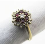 A 9ct Gold Ruby and Diamond Cluster Ring, claw set throughout.