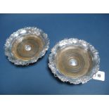A Pair of XIX Century Plated Bottle Coasters, each with shaped circular fruiting vine border and