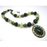 A Modern Faceted Bead Necklace, with gilt bead spacers, suspending large oval collet set panel