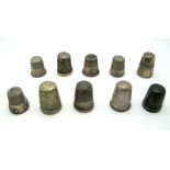 Ten Assorted Thimbles, including four hallmarked silver examples. (10)