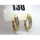 A Pair of Modern Diamond Set Half Hoop Earrings, each channel set with eight uniform brilliant cut