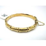 A 9ct Gold Bangle, of bamboo design, hinged to snap clasp.